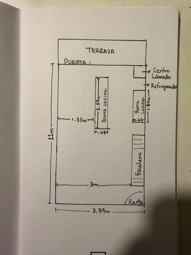 A phone photo of a ground-floor sketch drawn in pen on a dot-grid notebook page, with handwritten labels and dimension lines.
